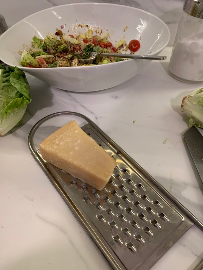 Rape Parmesan cheese to prepare the Caesar salad sauce 